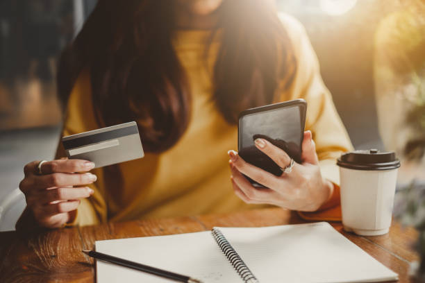 An online banking customer checks her credit card balance at her local credit union using her phone.