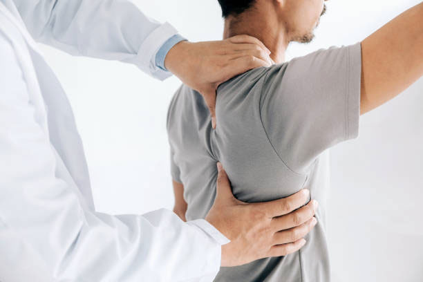 A chiropractor provides chiropractic treatments for a patient with back and shoulder pain.