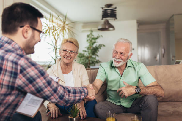 A couple meets with their local insurance agent to update their home insurance, life insurance and vehicle insurance policies.