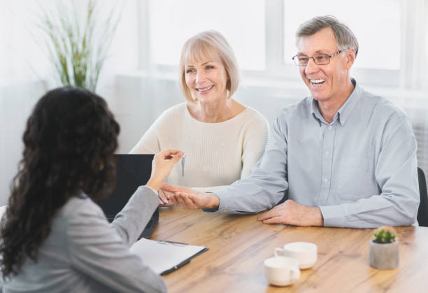 A couple meets with their mortgage broker to finalize paperwork for their home mortgage loan.