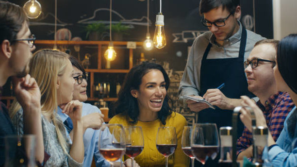 A group of friends meets at a local restaurant for a casual dinner and drinks.