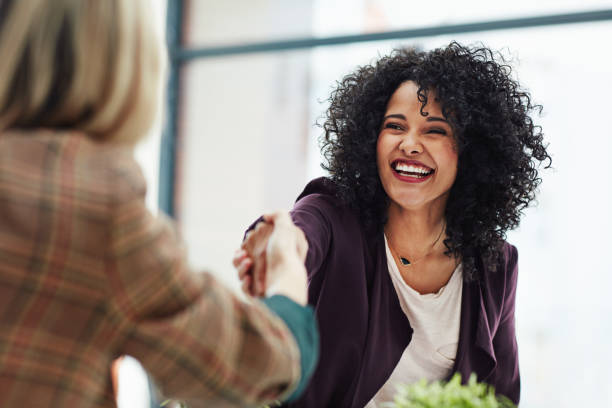A temp worker talks with staffing services at a local temp agency to find a temporary job placement at a local company that is hiring employees.